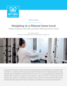 Scientist weighing a sample inside an Erlab ductless filtering fume hood using an Ohaus balance